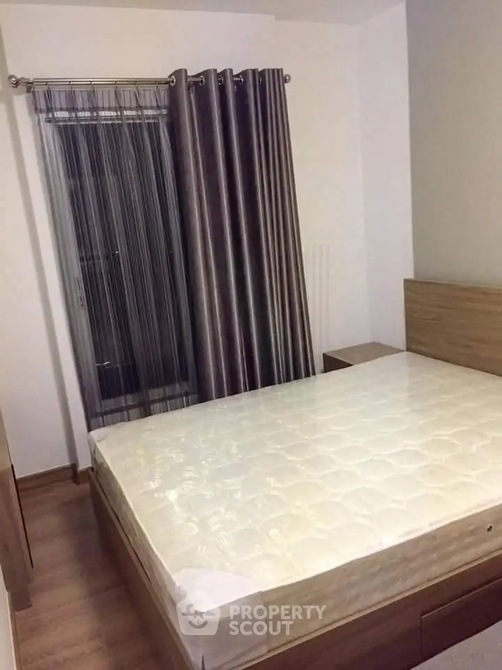 Cozy bedroom with modern furnishings and elegant curtains, perfect for restful nights.