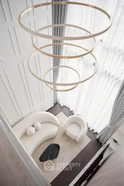 Luxurious modern living room with high ceilings and elegant circular chandelier