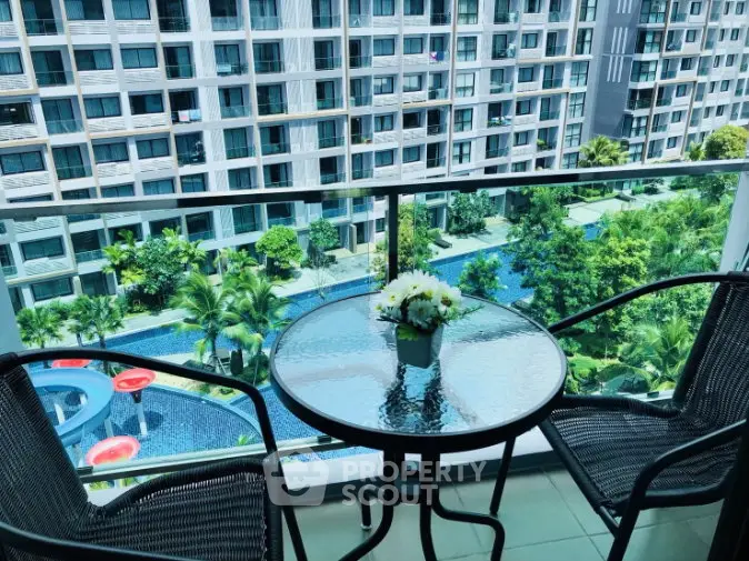 Charming balcony with pool view in modern apartment complex