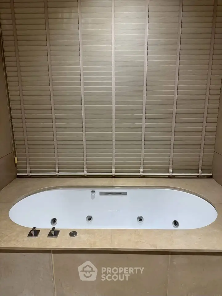 Luxurious bathroom with elegant bathtub and stylish blinds for a serene spa-like experience.