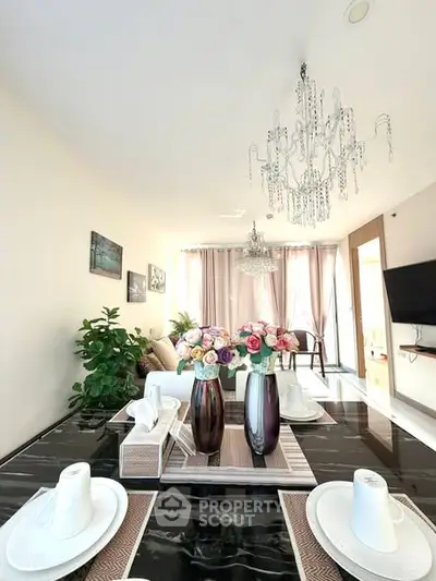 Elegant living room with chandelier and stylish decor, perfect for modern living.