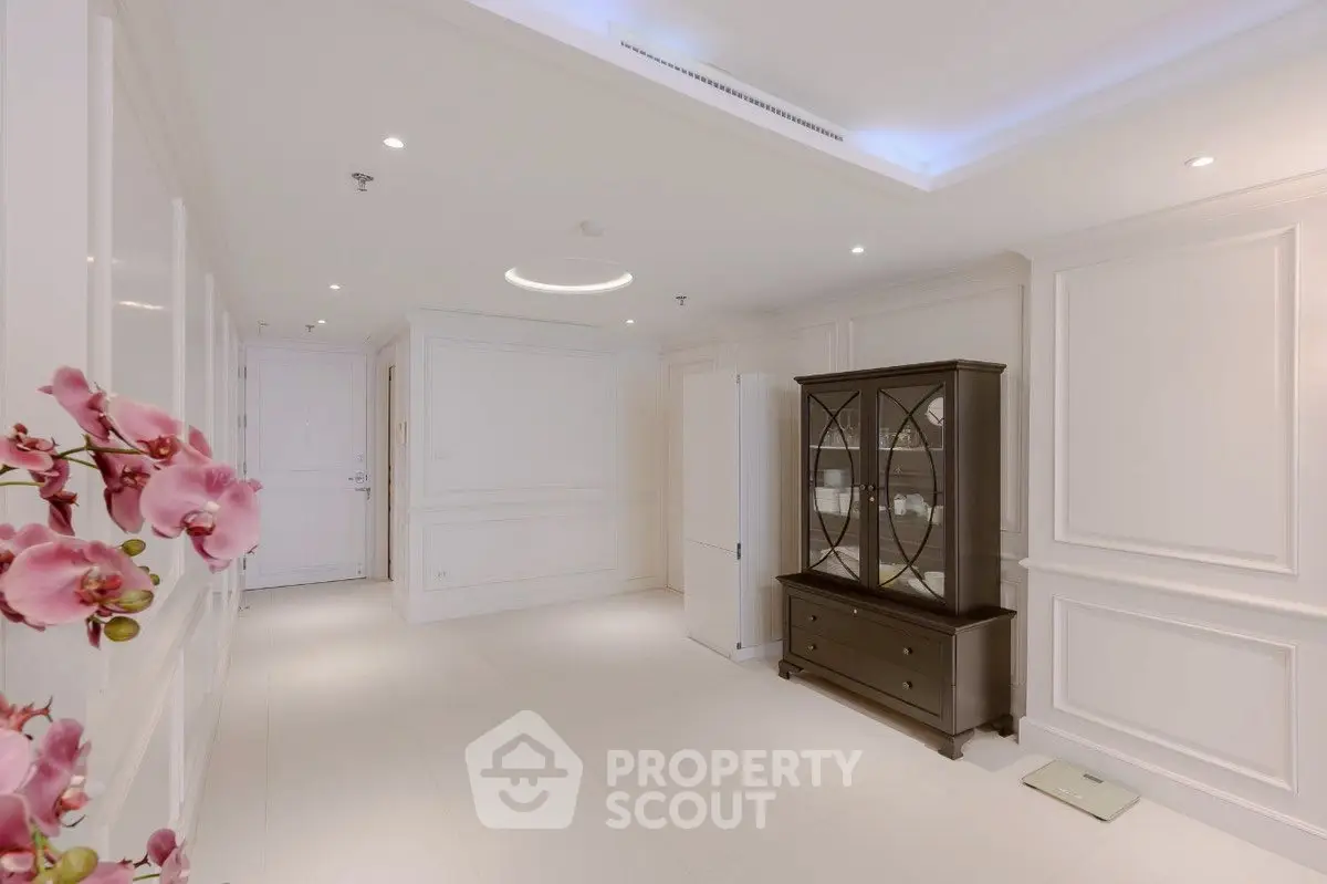 Elegant white interior room with classic furniture and floral decor