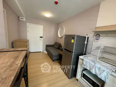 Modern compact living space with sleek furniture and kitchen appliances