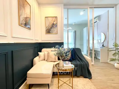 Chic living room with elegant decor and cozy seating in modern apartment.