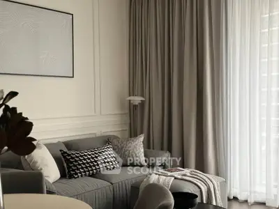 Elegant living room with modern decor and large window drapes