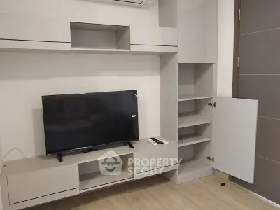 Modern living room with sleek TV unit and ample storage space