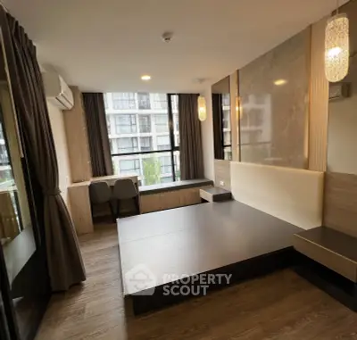 Modern living room with large windows and stylish lighting in a contemporary apartment.