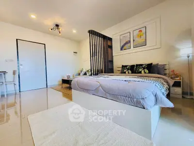Spacious modern bedroom with elegant decor and natural lighting