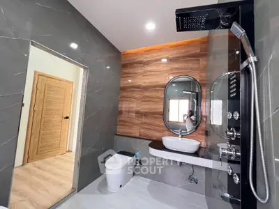 Luxurious modern bathroom with sleek fixtures and elegant wood accents.