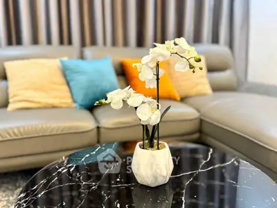 Elegant living room with modern sofa and stylish marble coffee table.