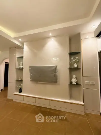Elegant living room with modern built-in shelves and recessed lighting