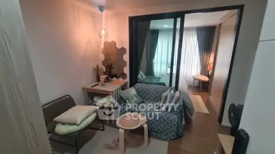Cozy living room with modern decor and natural light in a compact apartment.