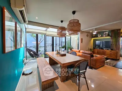 Stylish living room with modern decor, large windows, and cozy seating area.