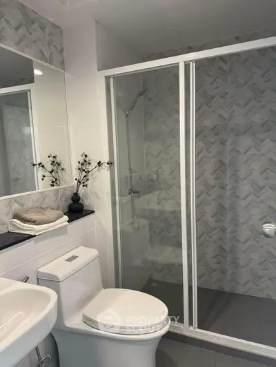 Modern bathroom with glass shower and elegant tile design