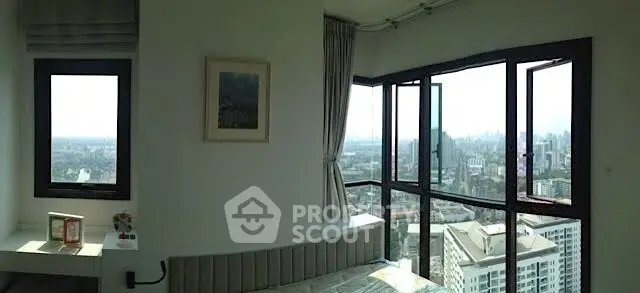 Stunning bedroom with panoramic city view from large windows, modern decor and cozy ambiance.