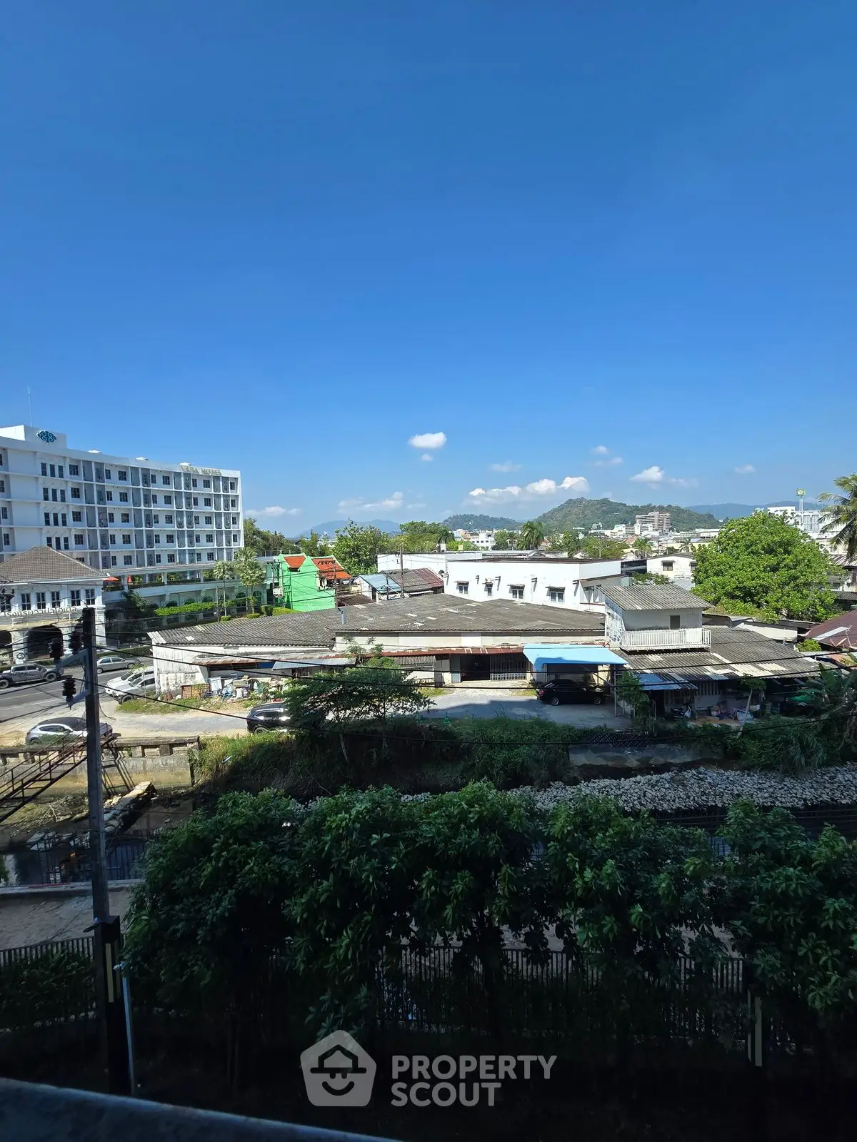 Scenic urban view with clear blue sky and residential buildings, ideal for city living.
