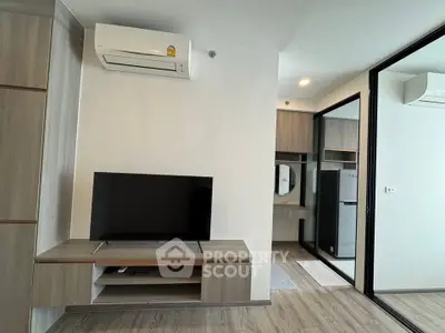Modern living room with sleek TV setup and air conditioning