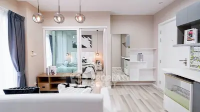 Modern open-plan living room with stylish decor and cozy bedroom view