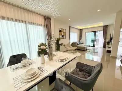 Luxurious open-plan living and dining area with elegant decor and natural light.