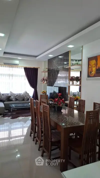 Elegant living and dining area with modern decor and natural light