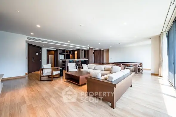 Spacious modern living room with open layout and elegant wooden flooring.