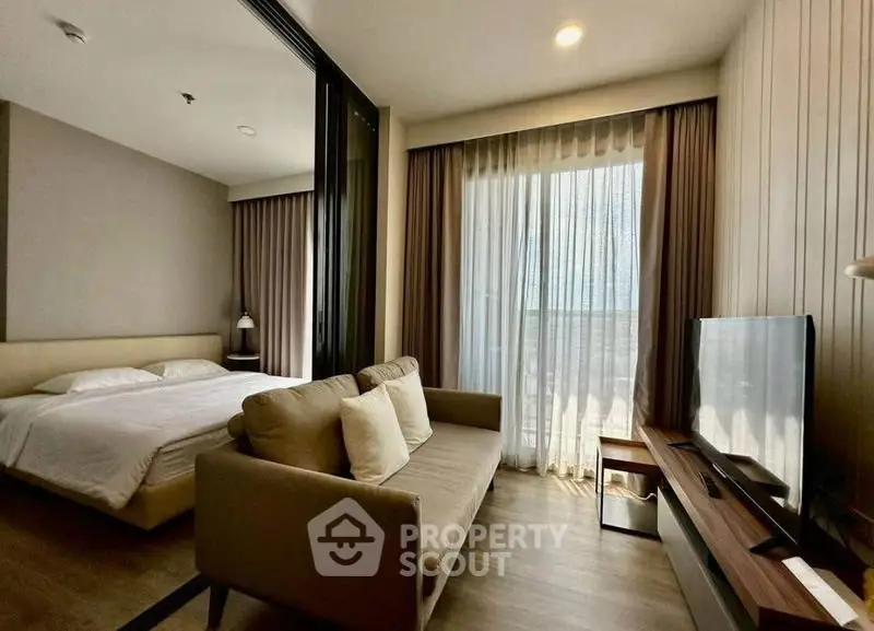 Modern studio apartment with cozy living area and natural light