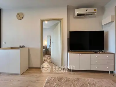 Modern living room with sleek furniture and air conditioning, showcasing a cozy and inviting atmosphere.