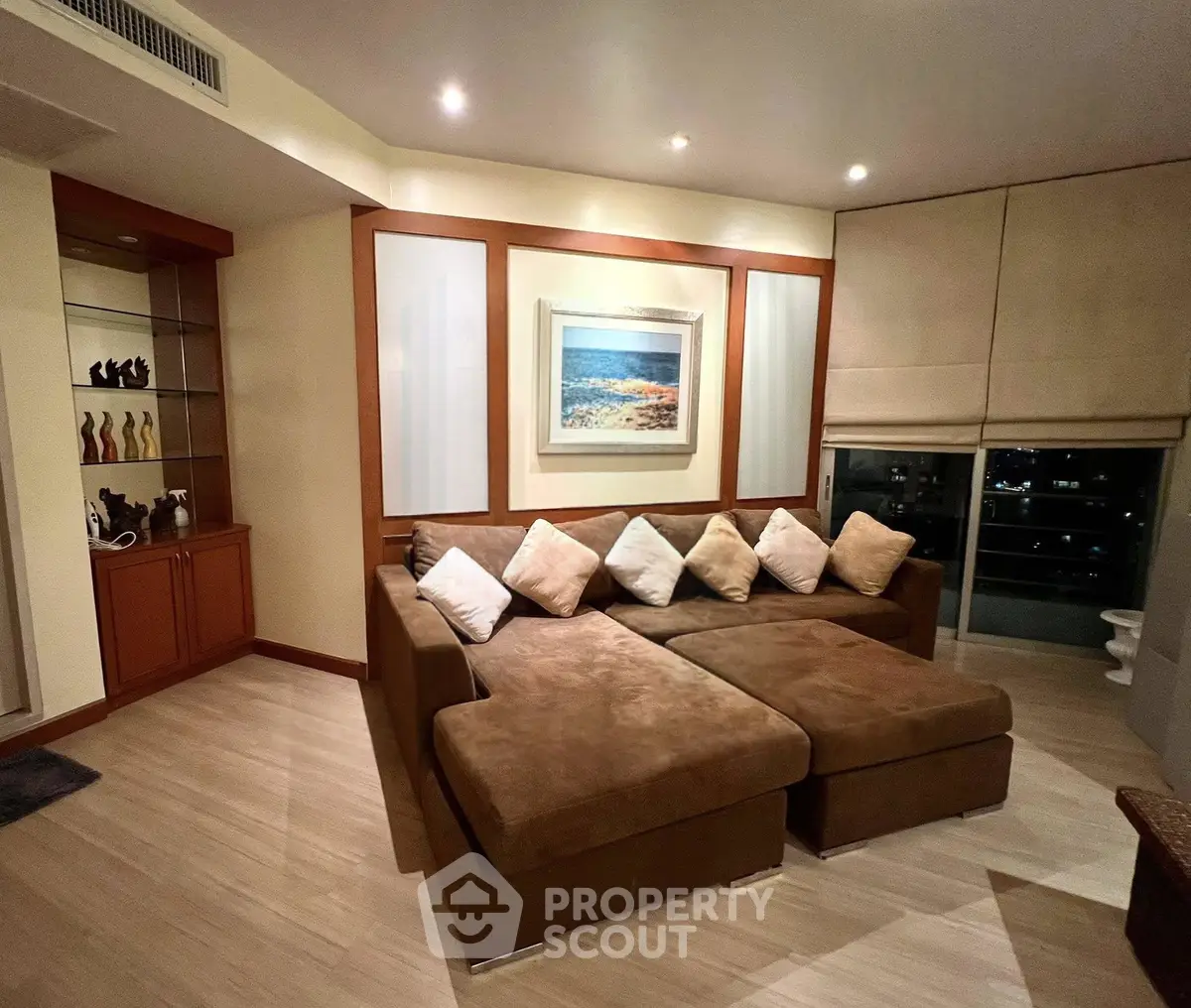 Spacious living room with cozy sectional sofa and elegant decor, perfect for relaxation and entertaining.