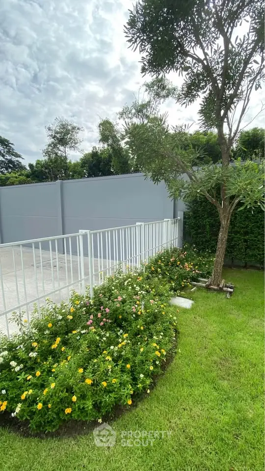 Charming garden view with lush greenery and vibrant flowers in a serene residential setting.