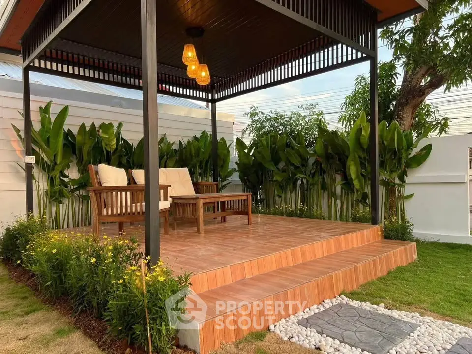 Charming outdoor patio with cozy seating and lush greenery, perfect for relaxation and entertaining.
