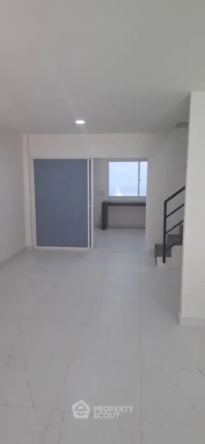 Modern minimalist interior with sleek staircase and spacious layout