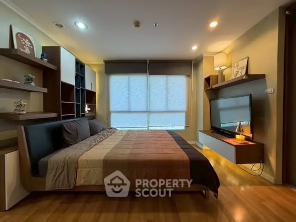 Modern bedroom with stylish decor and large window for natural light