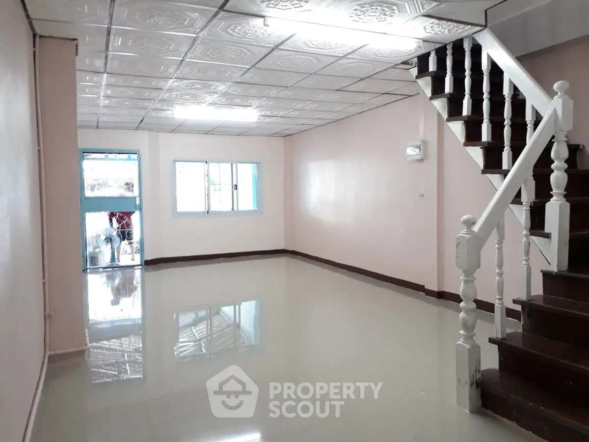 Spacious interior with glossy floors and staircase, perfect for customization.