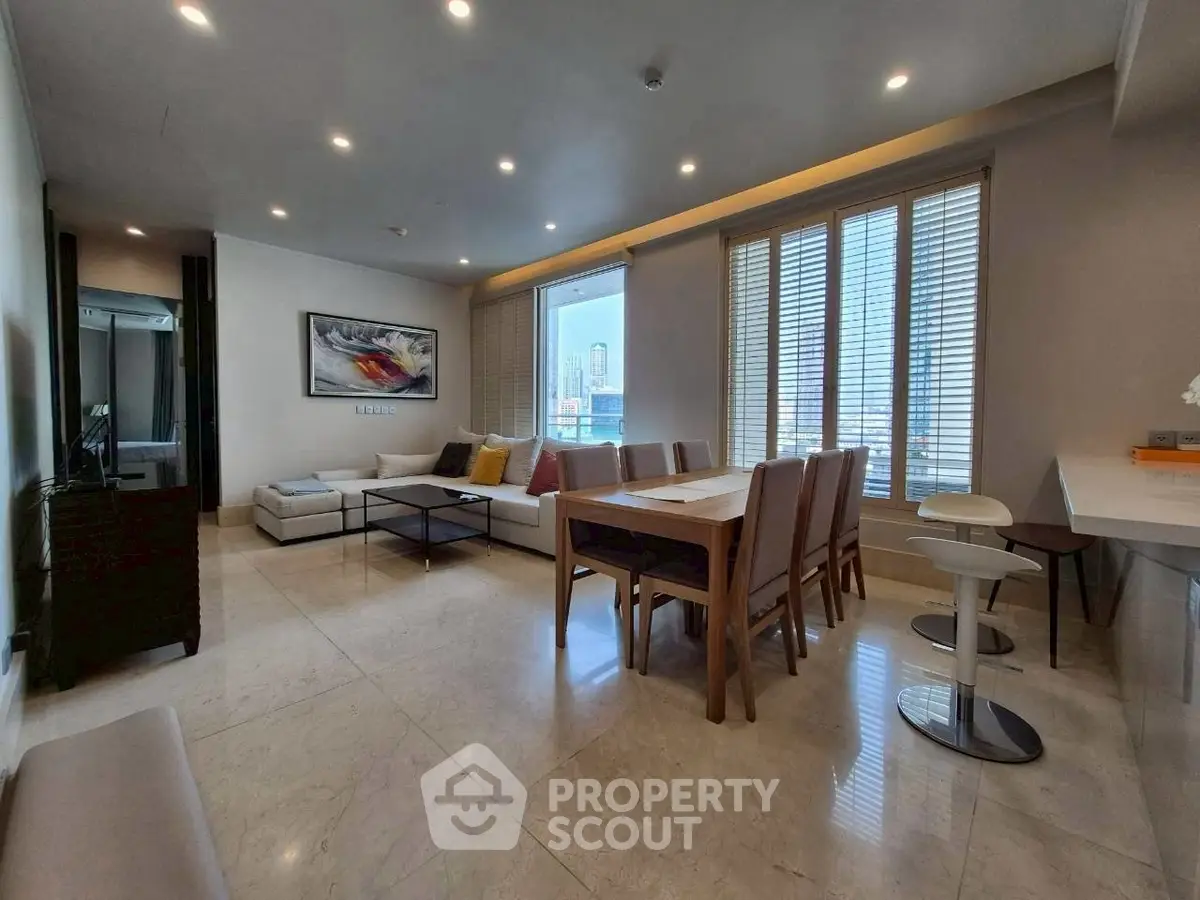 Spacious modern living room with dining area and city view