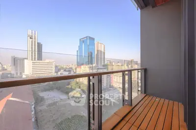 Stunning cityscape view from a modern balcony with sleek glass railing and wooden flooring.