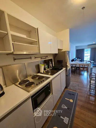 Modern kitchen with open layout and dining area in stylish apartment