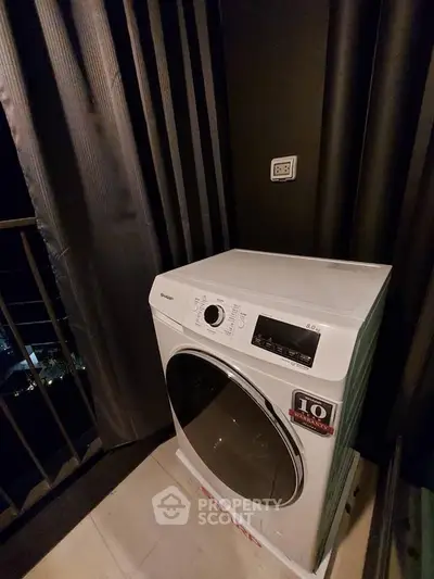 Modern washing machine on balcony with night view, perfect for urban living convenience.