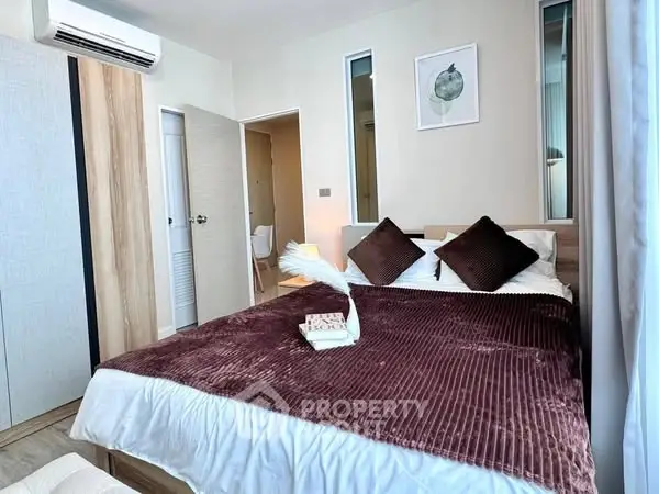 Cozy bedroom with modern decor and plush bedding in a stylish apartment.