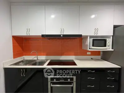 Modern kitchen with sleek cabinetry and built-in appliances