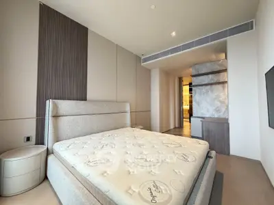 Luxurious modern bedroom with stylish decor and comfortable bed in a high-end apartment.