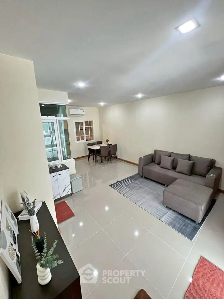 Spacious modern living room with sleek furniture and elegant decor in a bright apartment.