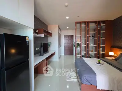 Modern bedroom with stylish decor and built-in shelving, featuring a cozy bed and sleek appliances.