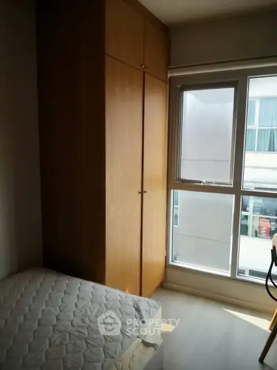 Cozy bedroom with natural light and built-in wardrobe