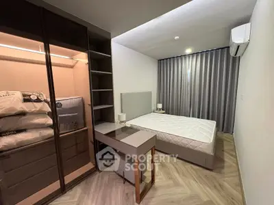 Modern bedroom with stylish furniture and ample storage in a contemporary apartment.