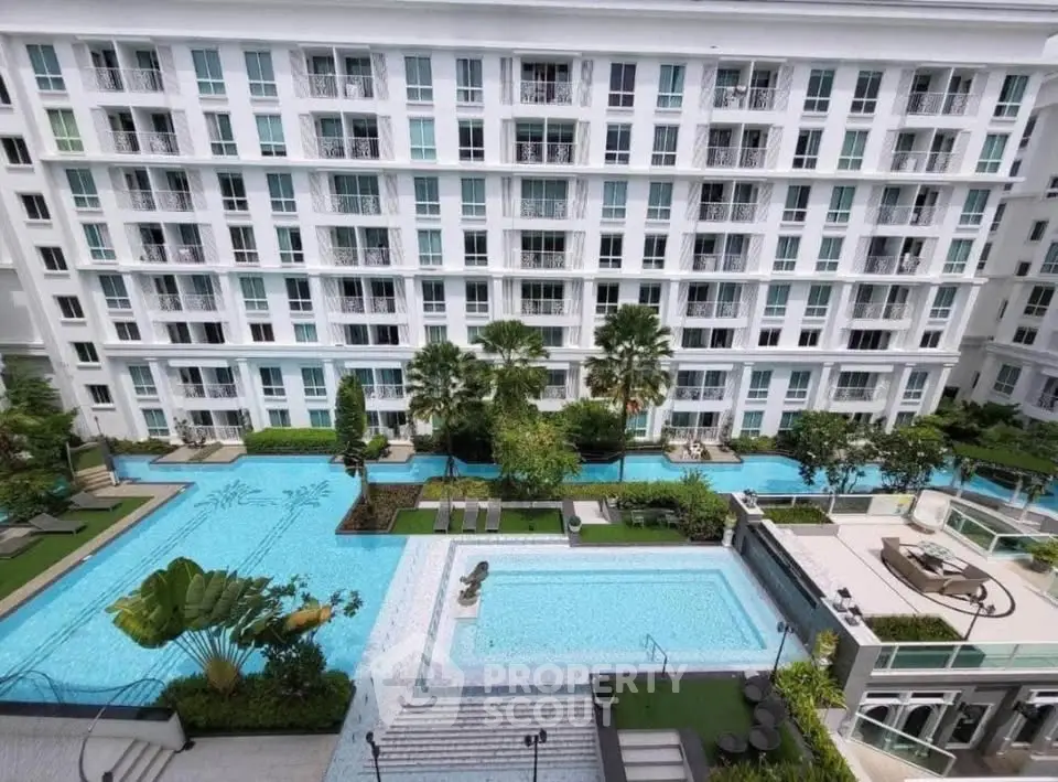 Luxurious apartment complex with stunning pool and lush greenery