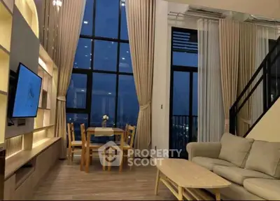 Luxurious high-ceiling living room with stunning night view and elegant decor.