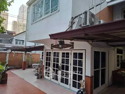 Charming urban home with spacious patio and modern exterior design, perfect for city living.