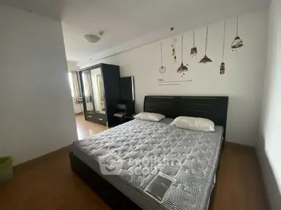 Spacious bedroom with modern decor and ample natural light