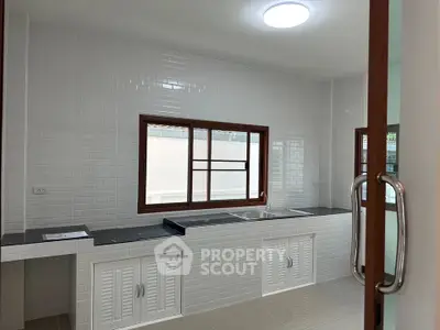 Modern kitchen with sleek countertops and ample natural light