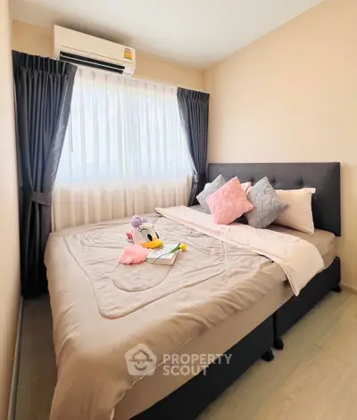 Cozy bedroom with plush bedding and natural light, perfect for relaxation.